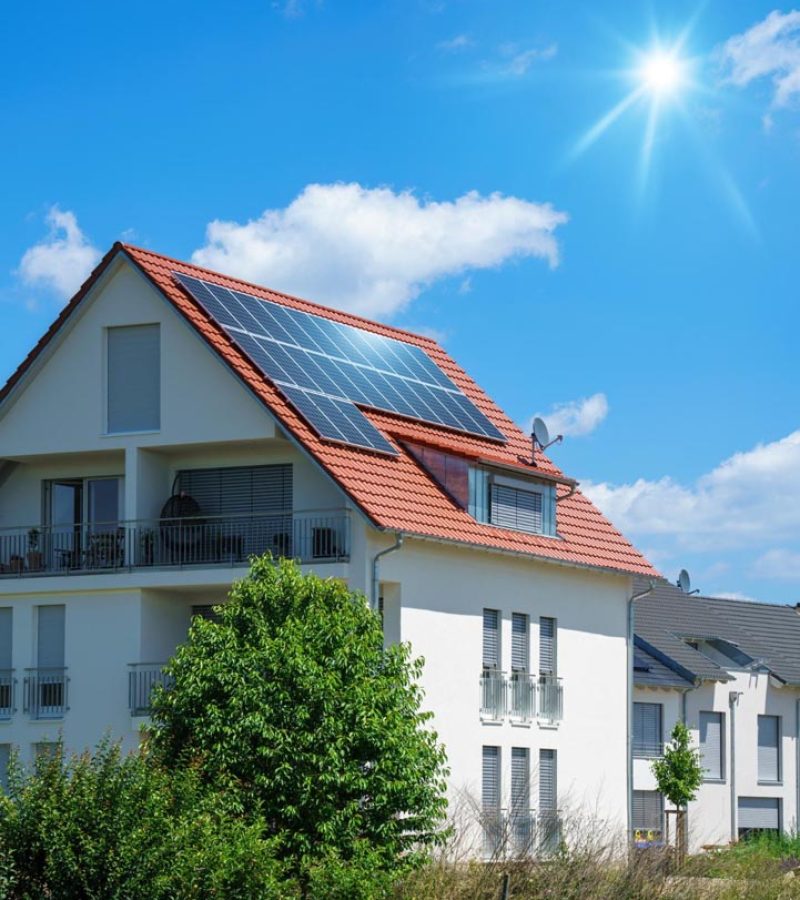 home-with-solar-energy-green-plants-sunny-blue-sky